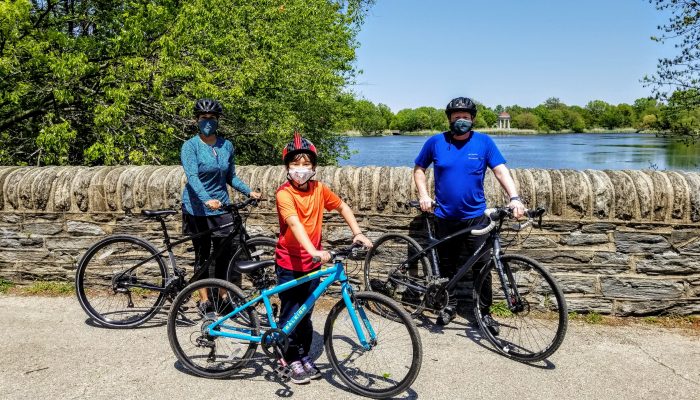 A family of cyclists wearing masks in FDR Park.