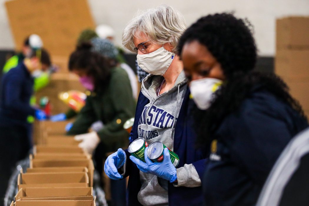 Individuals gathering food from a food distribution site