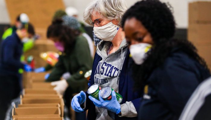 Individuals gathering food from a food distribution site