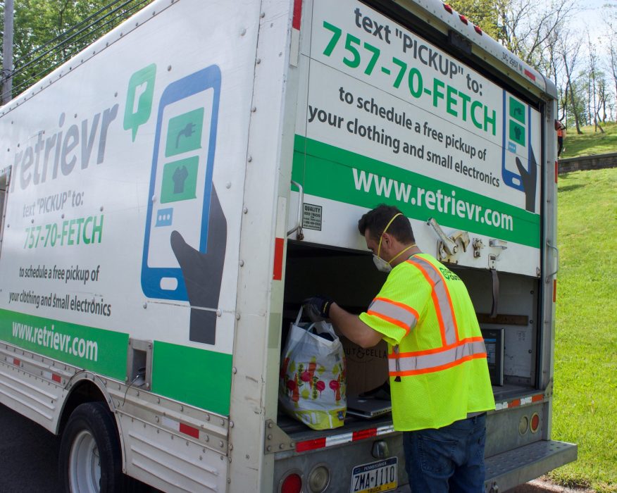 Retrievr employee picking up waste and putting it in the truck
