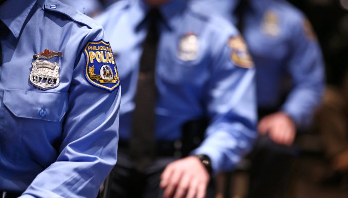 Three uniformed police officers in a line