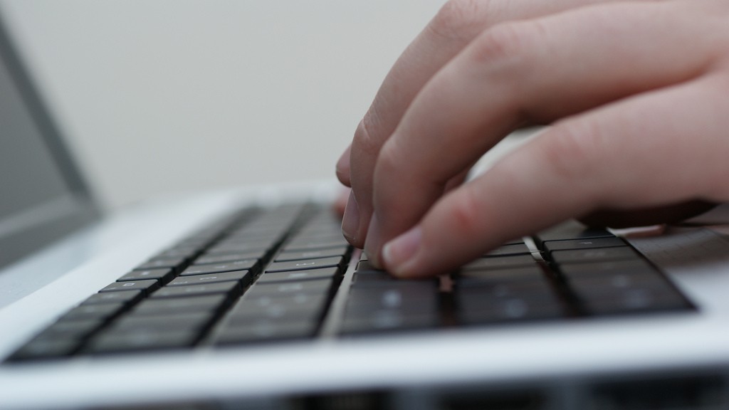 person typing on a laptop