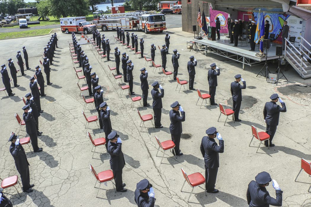 cadets standing on asphalt and saluting in daylight