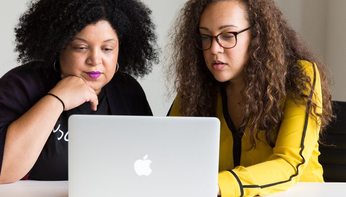 Two women looking at a laptop