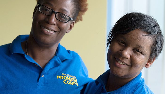 A Promise Corps staff member and student