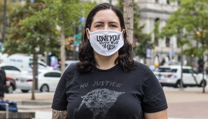 Casey wearing a mask that says Love your neighbor. Wear a mask.