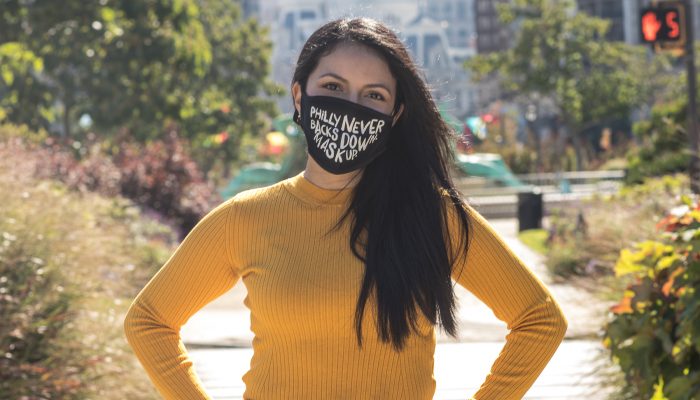 Joy Huertas wearing a mask that says Philly doesn't back down. We mask up.