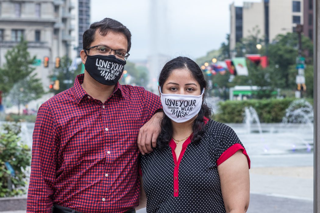 Bhumika and Jigar posing together and wearing masks