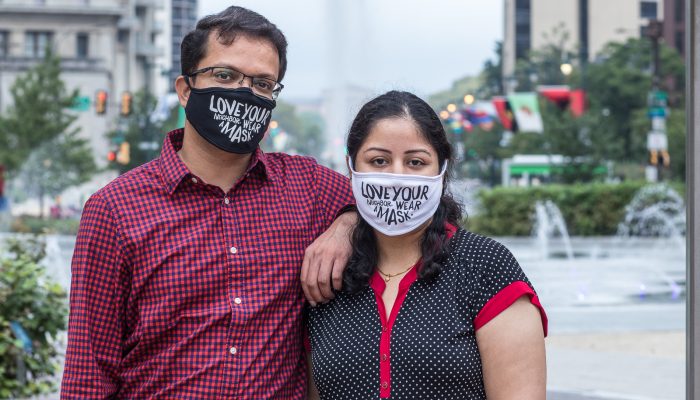 Bhumika and Jigar posing together and wearing masks