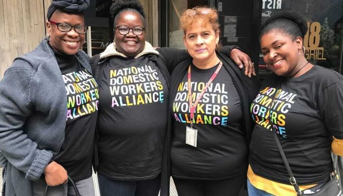 Four women wearing shirts that read "National Domestic Workers Alliance."