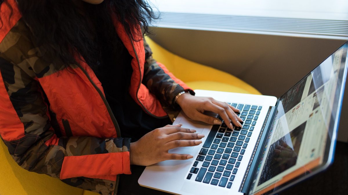A woman typing on a laptop