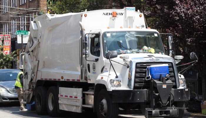 trash truck on city street