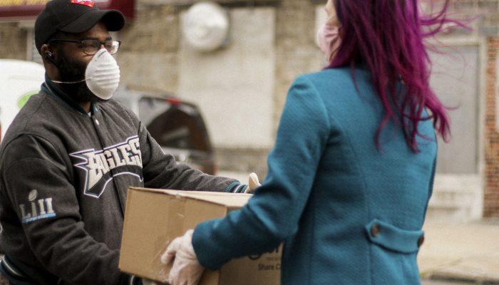 Volunteer handing a food box