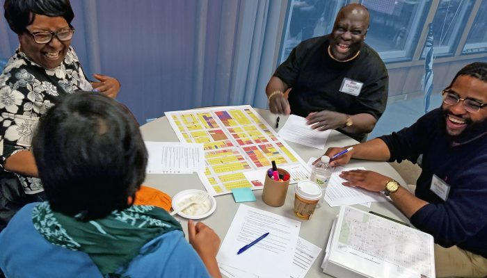 citizen planning institute members sitting around a table laughing