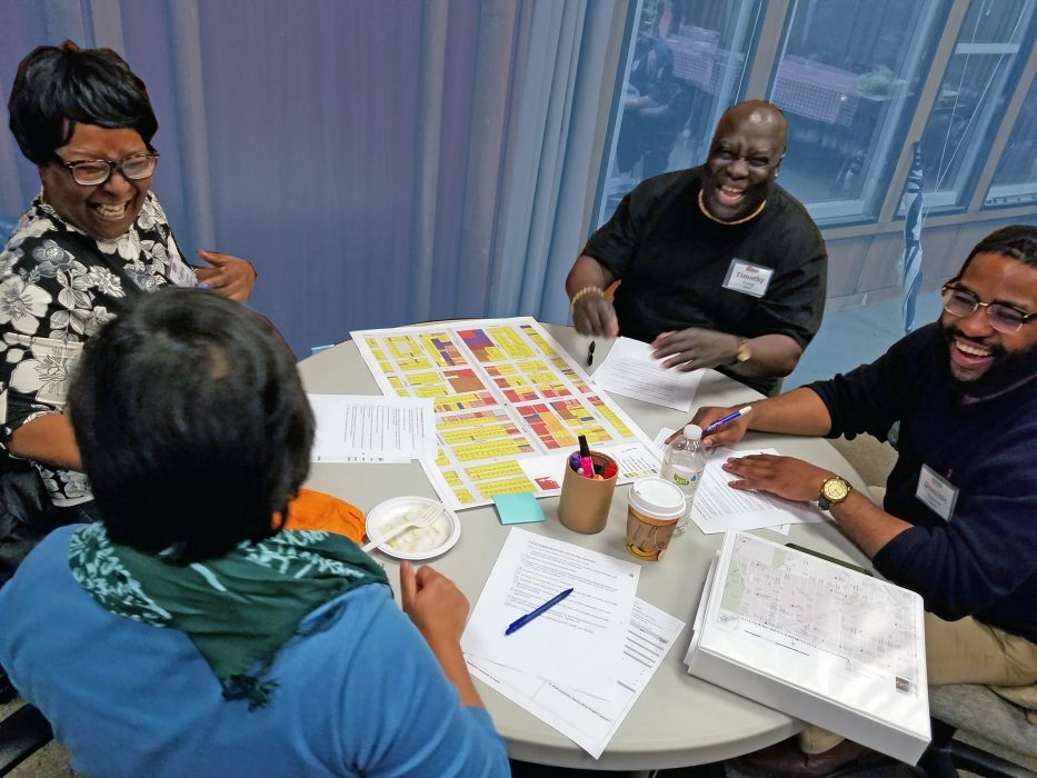 citizen planning institute members sitting around a table laughing