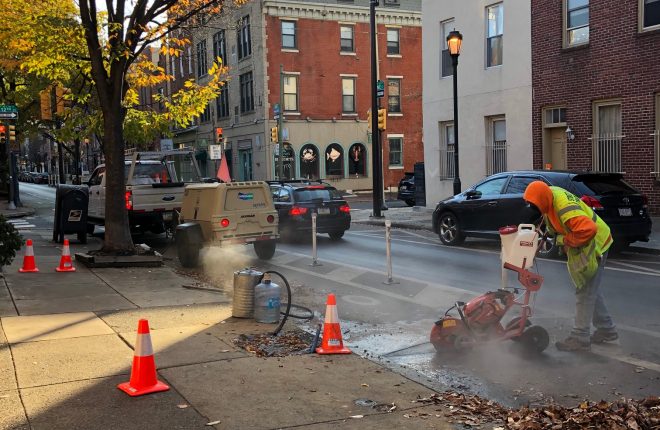 crew member installs bicycle counter in the street