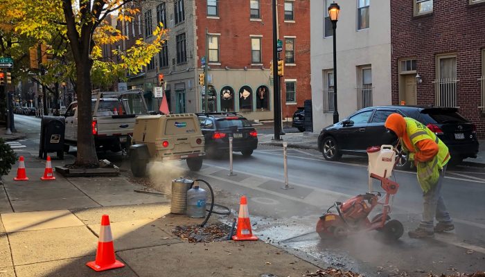 crew member installs bicycle counter in the street