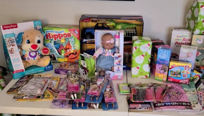 Children's toys sitting on a table demonstrating the wide variety of toys donated to children in the City's Isolation and Quarantine Site