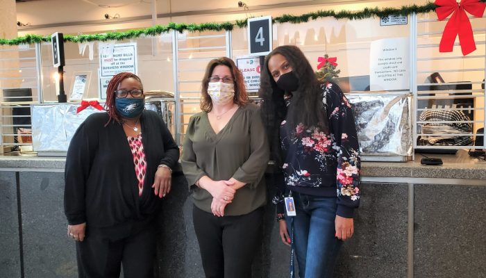 Cashiers pose for a photo at the Municipal Services Building