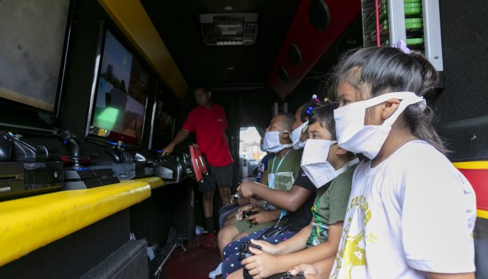 Children wearing masks play video games