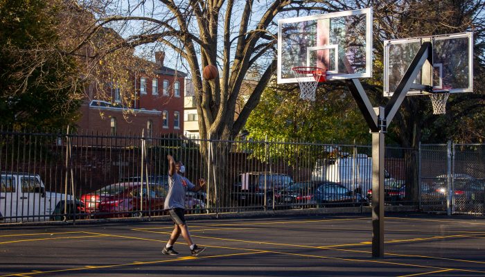 Boy playing basketball in mask