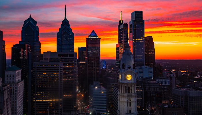 a vibrant sun set with the city of philadelphia skyline in the foreground