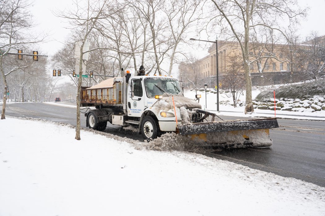 a plow clearing the street of snow