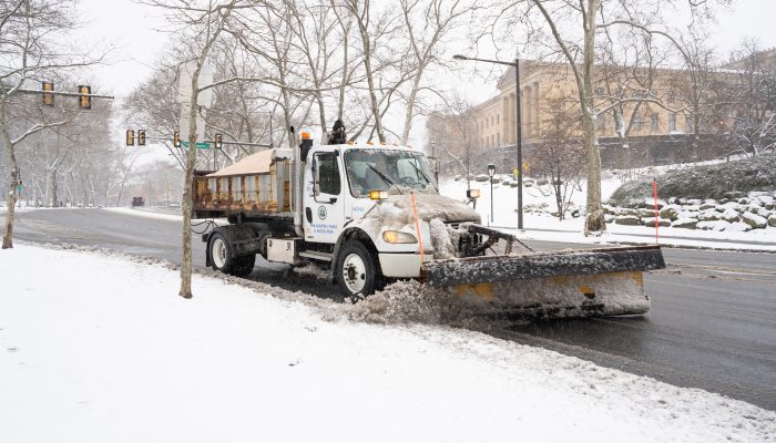 a plow clearing the street of snow