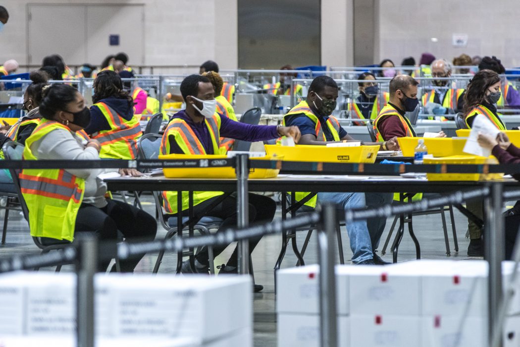 Large group of people working to count ballots during the 2020 election.