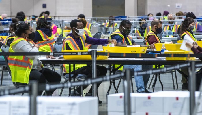 Large group of people working to count ballots during the 2020 election.