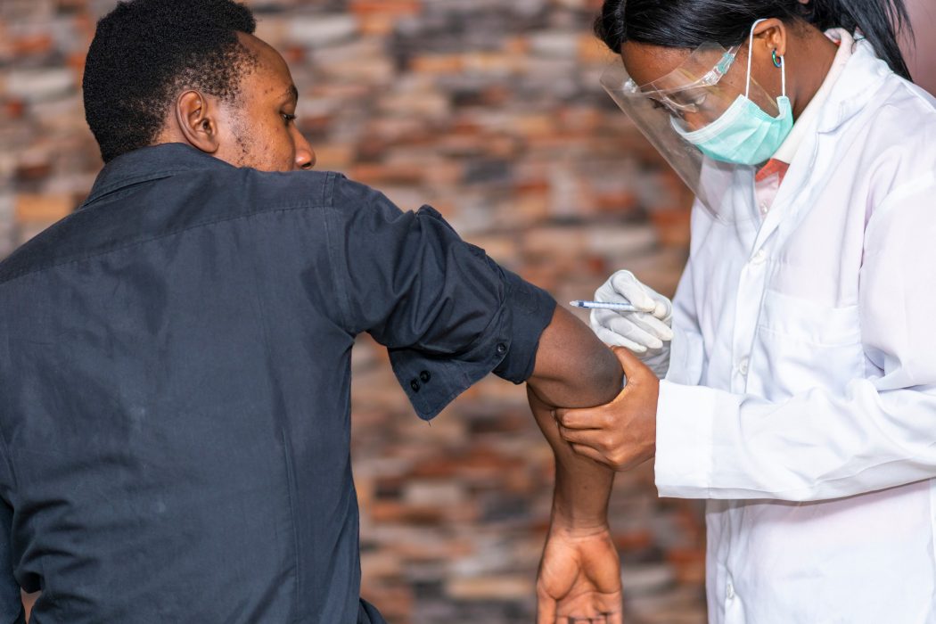 a person getting a covid vaccine from a doctor