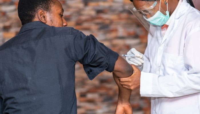 a person getting a covid vaccine from a doctor