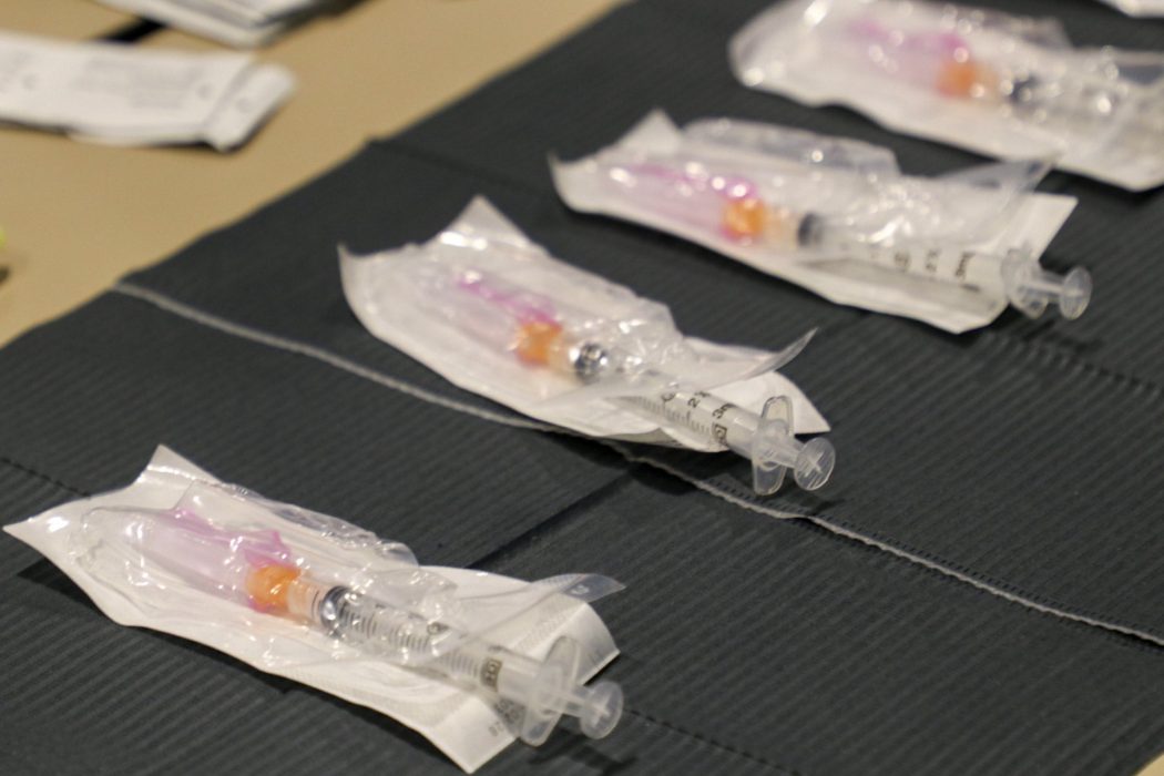 COVID Vaccines lined up on a table for distriution