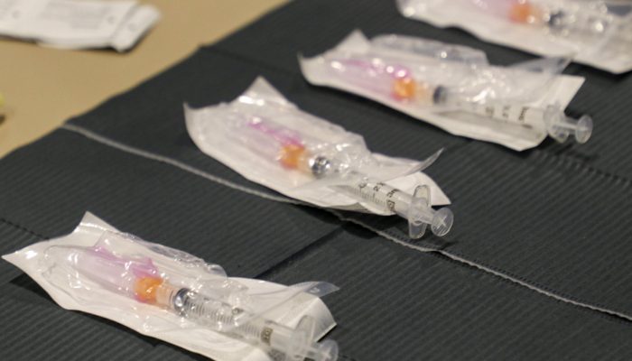 COVID Vaccines lined up on a table for distriution