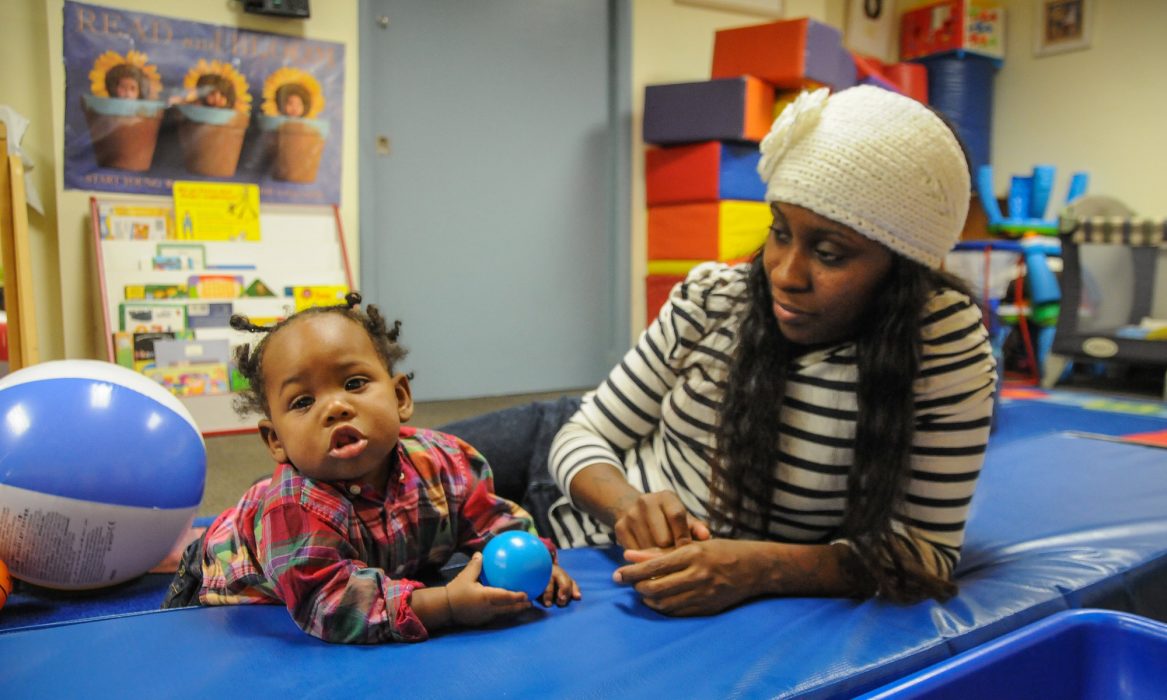 A parent and child play together.