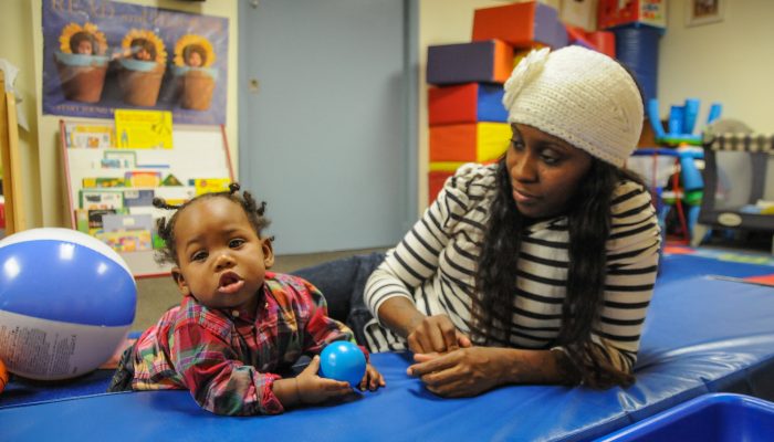 A parent and child play together.