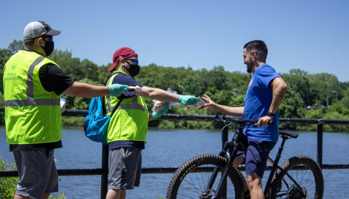 Philadelphia Parks and Rec representatives hand out masks along the the trail