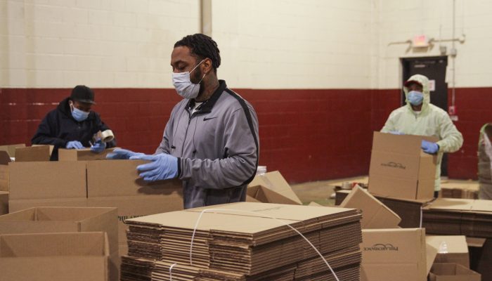 volunteers assembling boxes as part of the city's food distribution