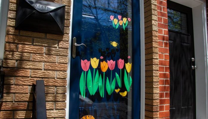 Flowers painted on a doorway of a rowhome in Philadelphia