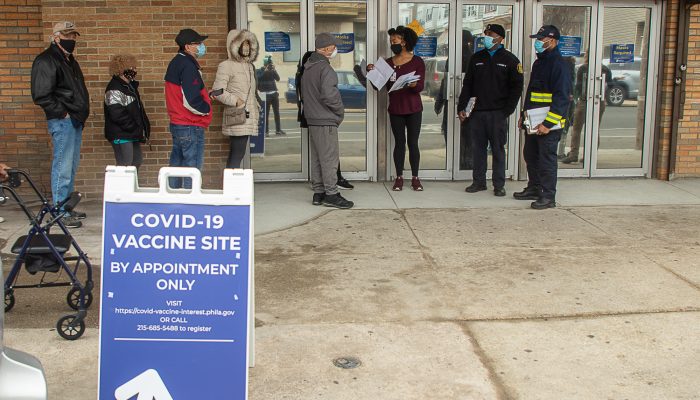 Volunteer outside vaccination clinic