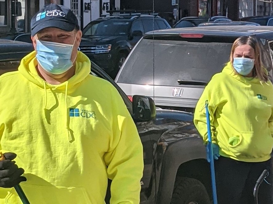 Cleaning Ambassadors employed through the PHL Taking Care of Business Program sweeping sidewalks