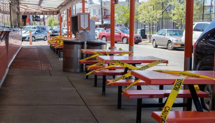 Tables outside a South Philly restaurant are closed off with tape so clients will not use them during COVID-19 pandemic