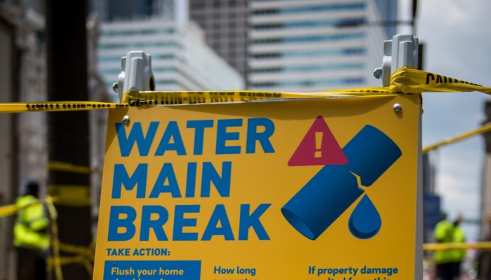 A sign that reads "Water Main Break" outside of a Water Department work site in downtown Philadelphia