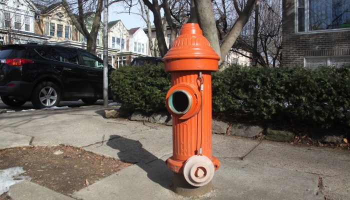 A fire hydrant with a missing cap on the front