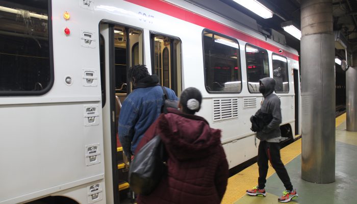 People getting on a SEPTA trolley.