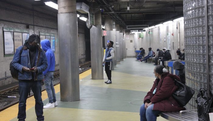 People waiting on a platform at the subway station.