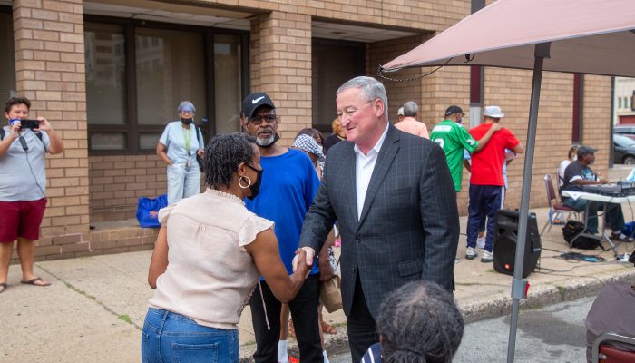mayor kenney shaking hands with a community member