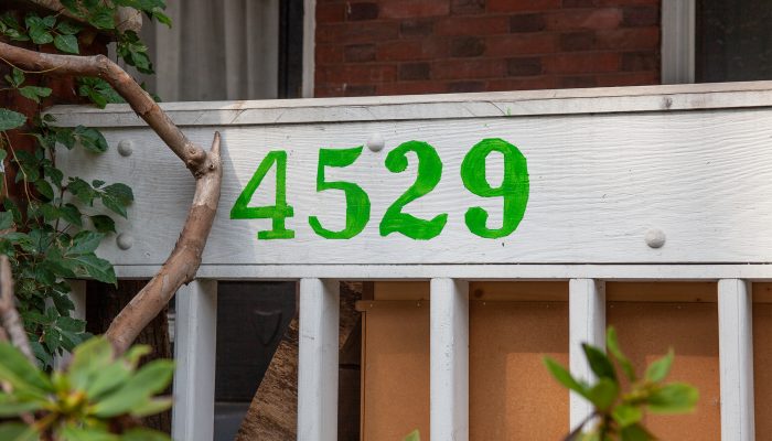 A house number painted on a front fence that reads 4529
