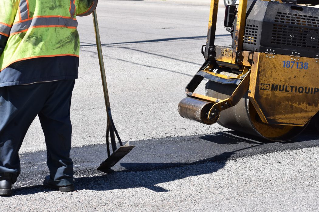 Smooth pavement after a machine has smoothed over the pothole with new tar