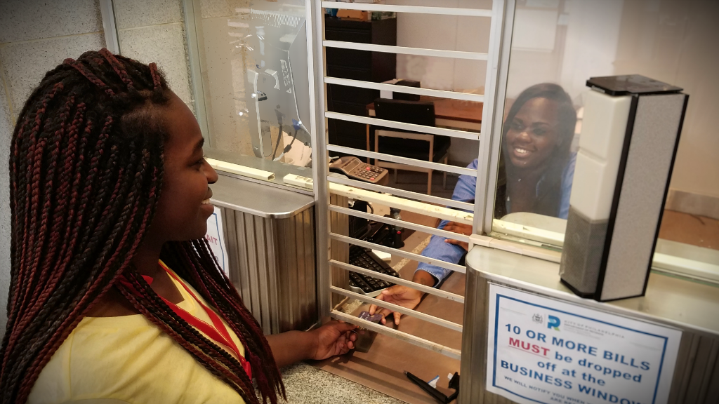 Customer pays bills at a counter